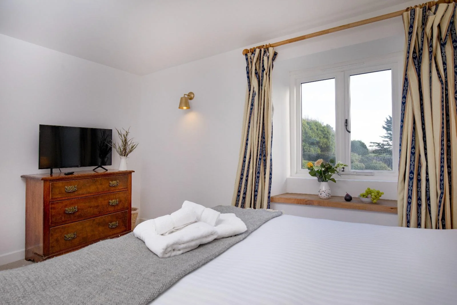 King-size bedroom with window seat and television