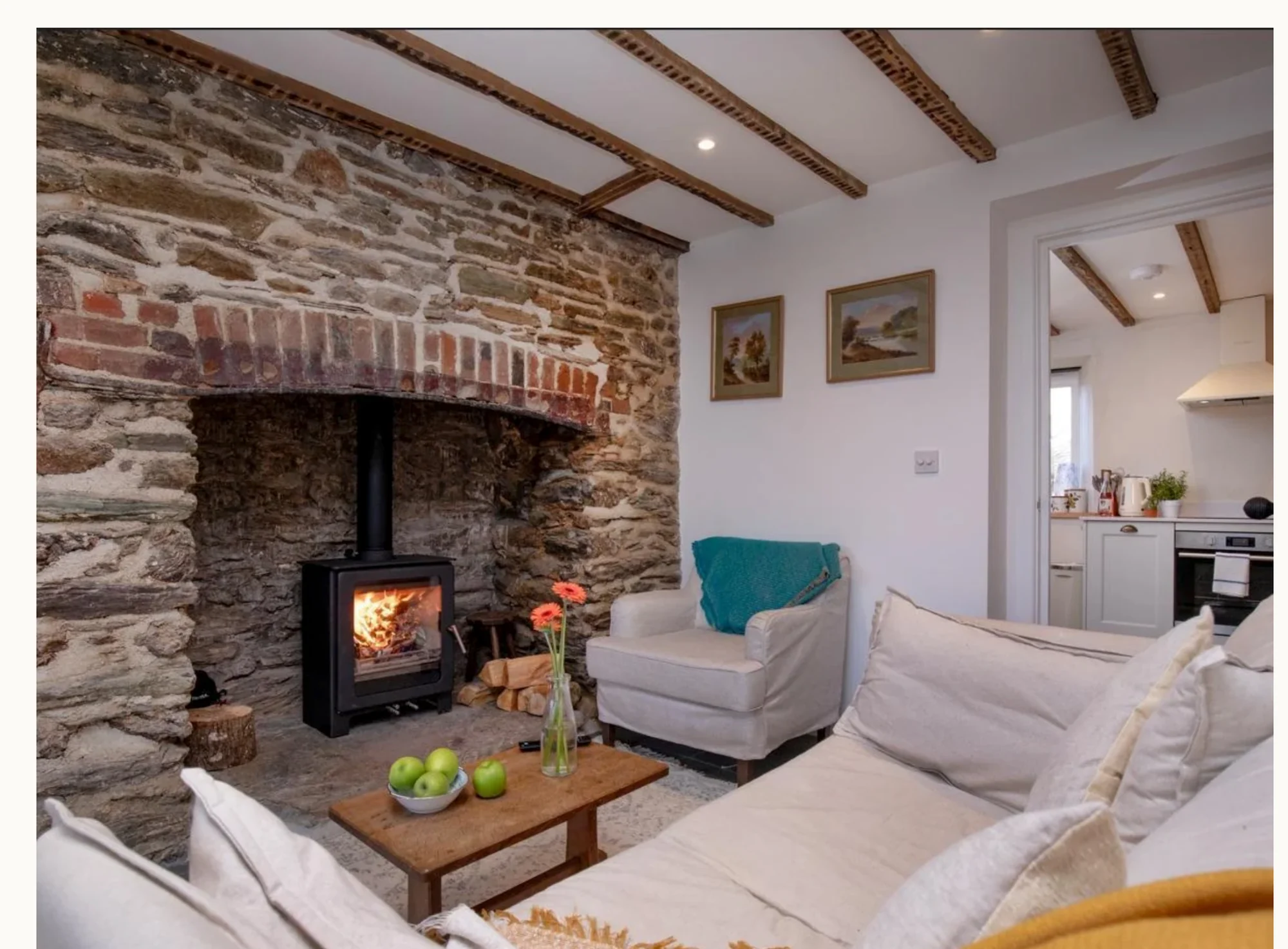 Living room with stone fireplace and wood burner
